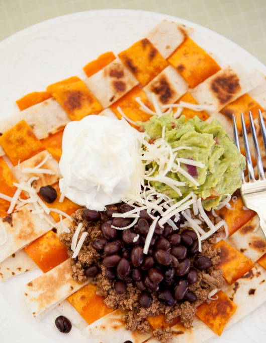 Woven Tortillas, served with taco meat, black beans, guacamole, sour cream and cheddar cheese. Use knife and fork to eat.